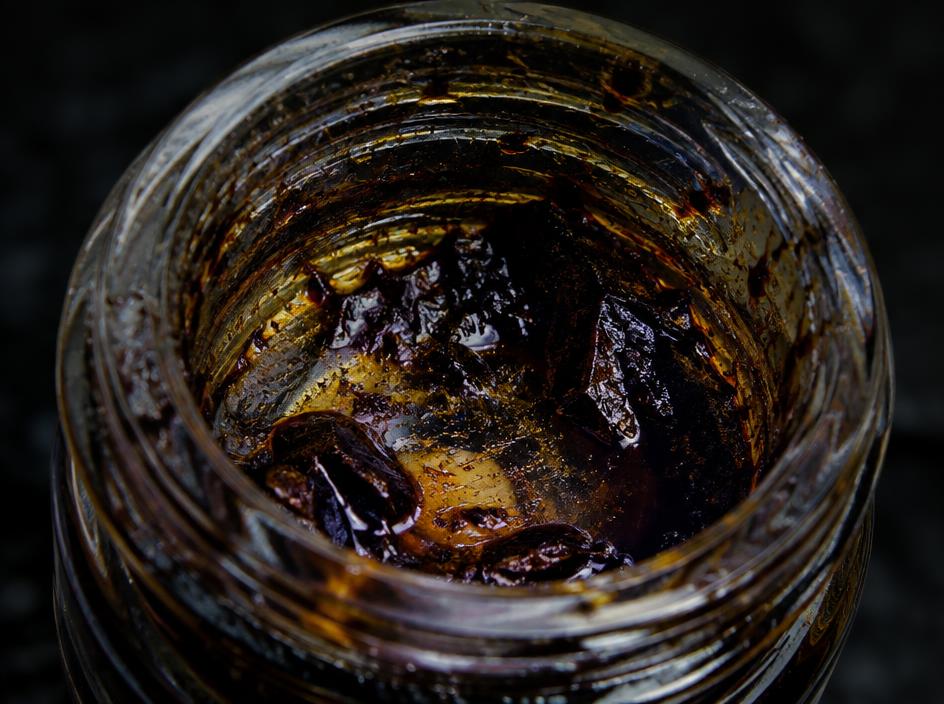 Nearly empty concentrate jar with cured rosin residue